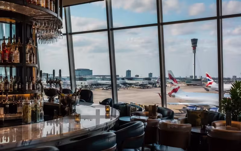 Airport wine bar overlooking the runway and departing aircraft.